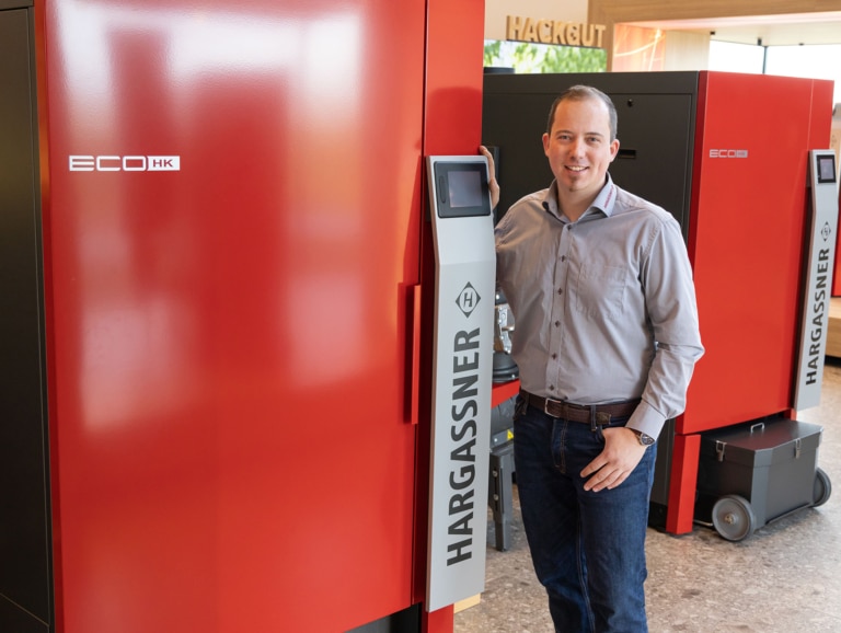 Stefan Kopp, CEO North America, next to Eco-HK wood chip boiler